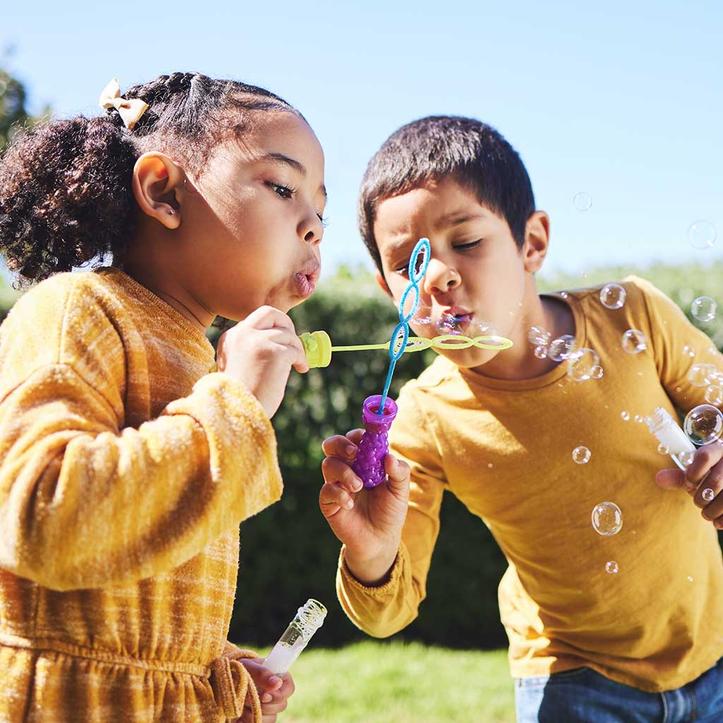 Kids Playing With Bubbles in the Park